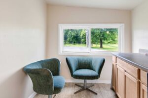 Two easy chairs, base unit with cupboards