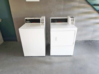 Coin operated washing machine and dryer for guest use